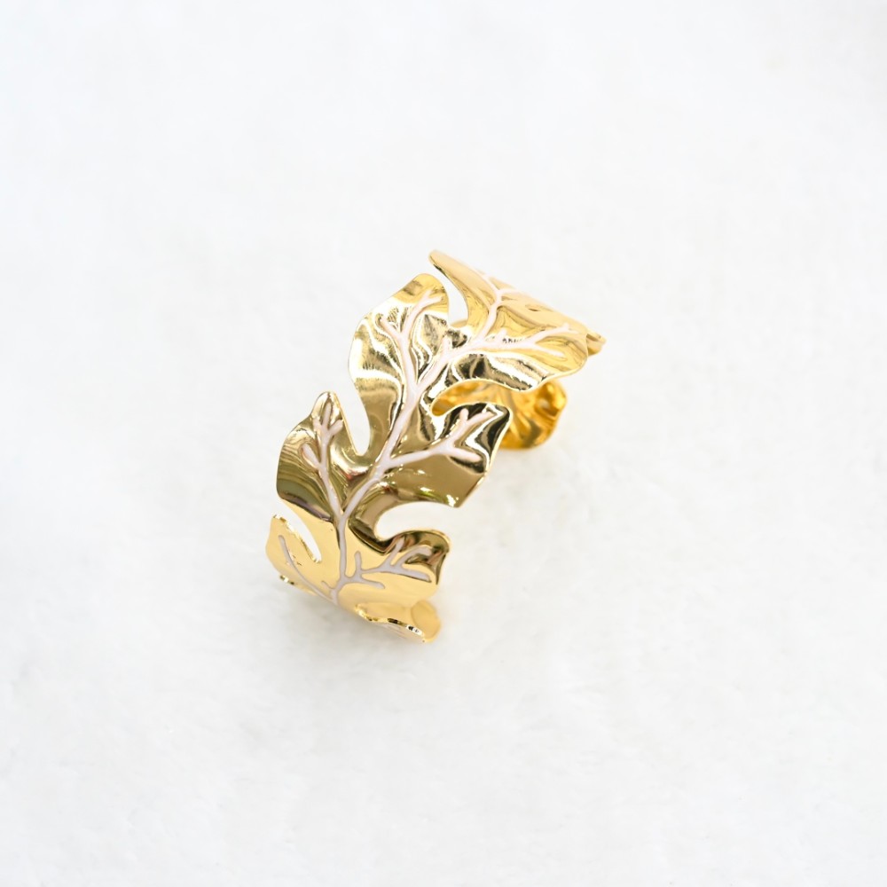 Gold leaf open cuff bracelet with sculptural leaf cutout design, polished gold-tone finish and adjustable open bracelet style for wholesale jewelry buyers