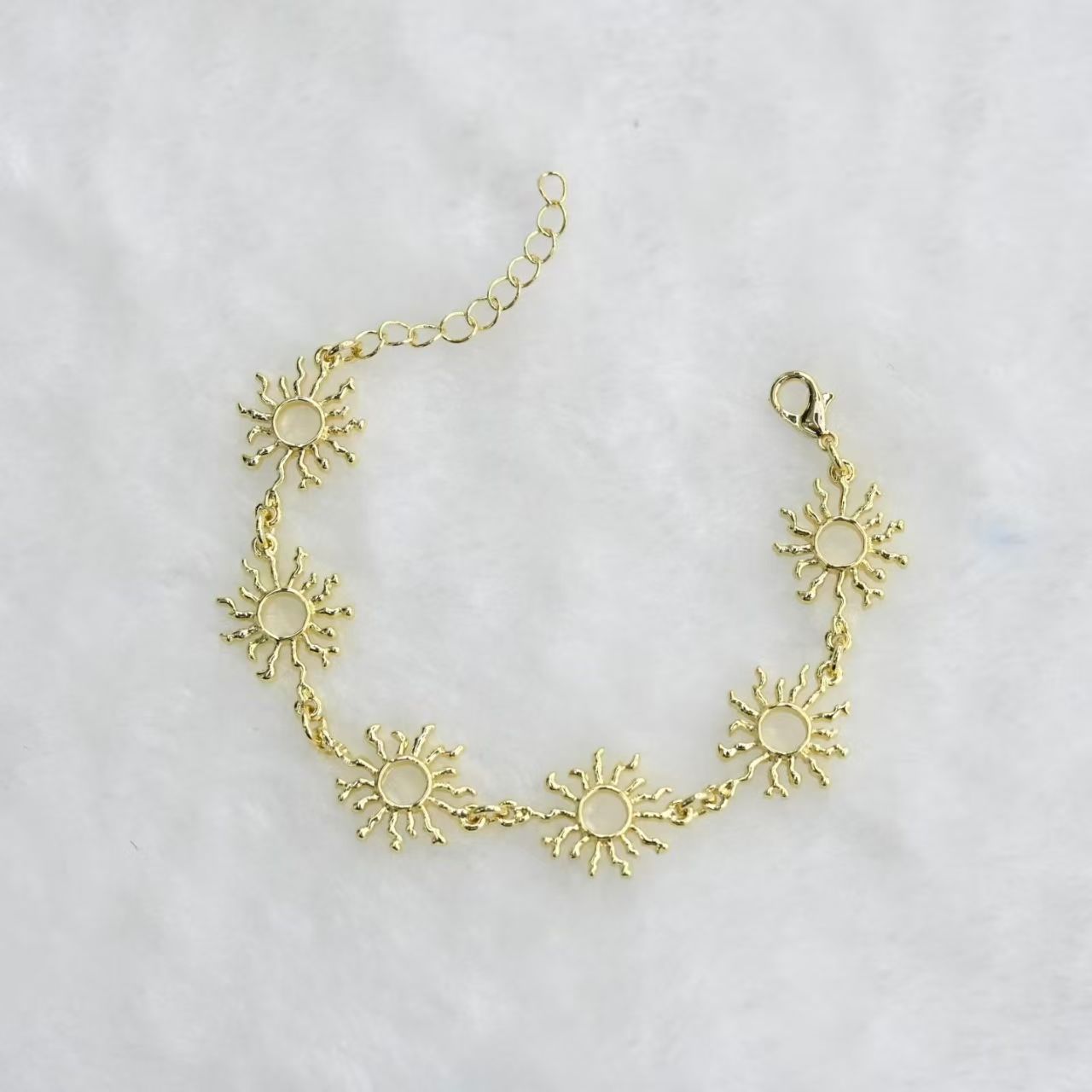 Gold and silver sun charm chain bracelets with multiple sun pendants, lobster clasp and adjustable extension chain for wholesale jewelry buyers