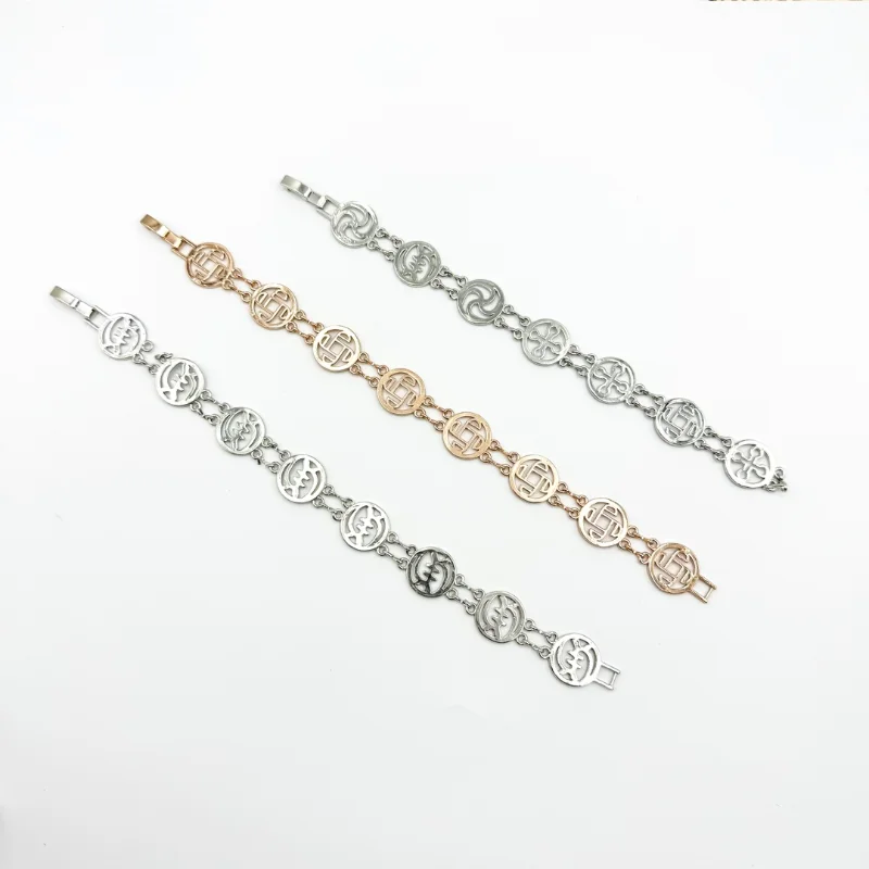Mixed metal medallion link bracelets set with silver, rose gold and silver-tone round openwork charm designs for wholesale jewelry buyers