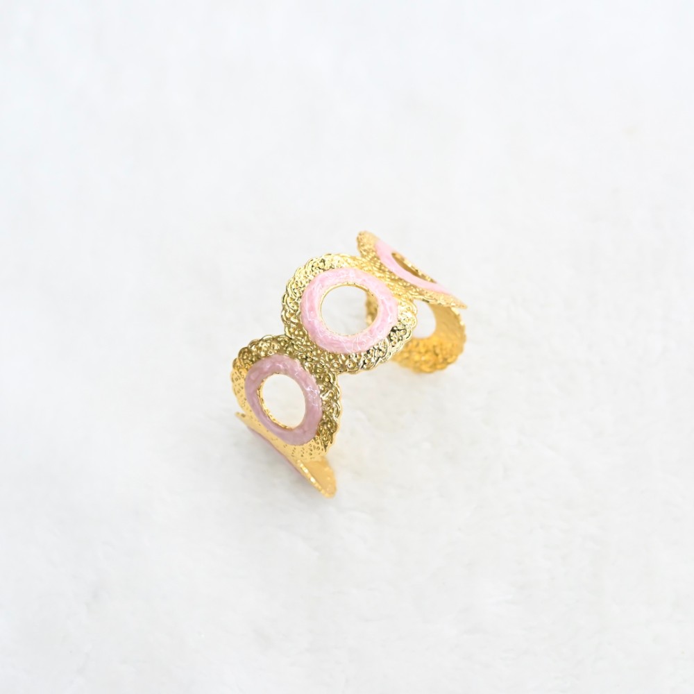 Pink circle gold cuff bracelet with round openwork design, textured gold-tone frame and pink enamel-style ring details for wholesale jewelry buyers
