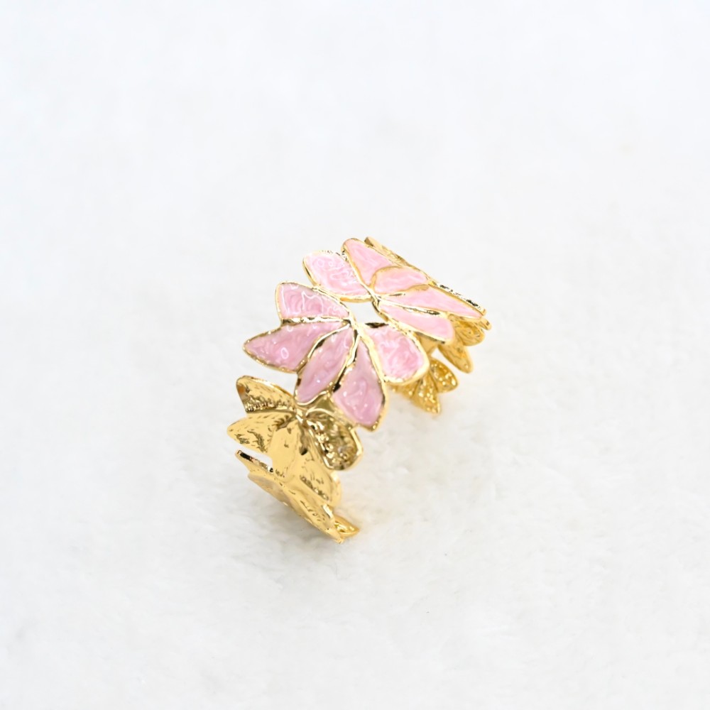 Pink flower gold leaf cuff bracelet with enamel-style petals, textured gold-tone leaves and open statement design for wholesale jewelry buyers