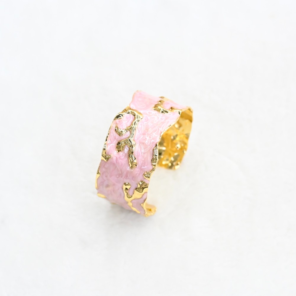 Pink marble-style irregular gold cuff bracelet with hammered gold-tone cutout details and open adjustable design for wholesale jewelry buyers