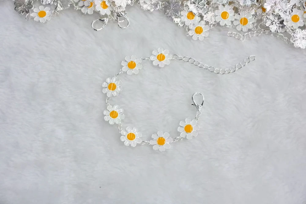 Silver daisy flower chain bracelet with polished floral links and adjustable extension chain for wholesale jewelry buyers
