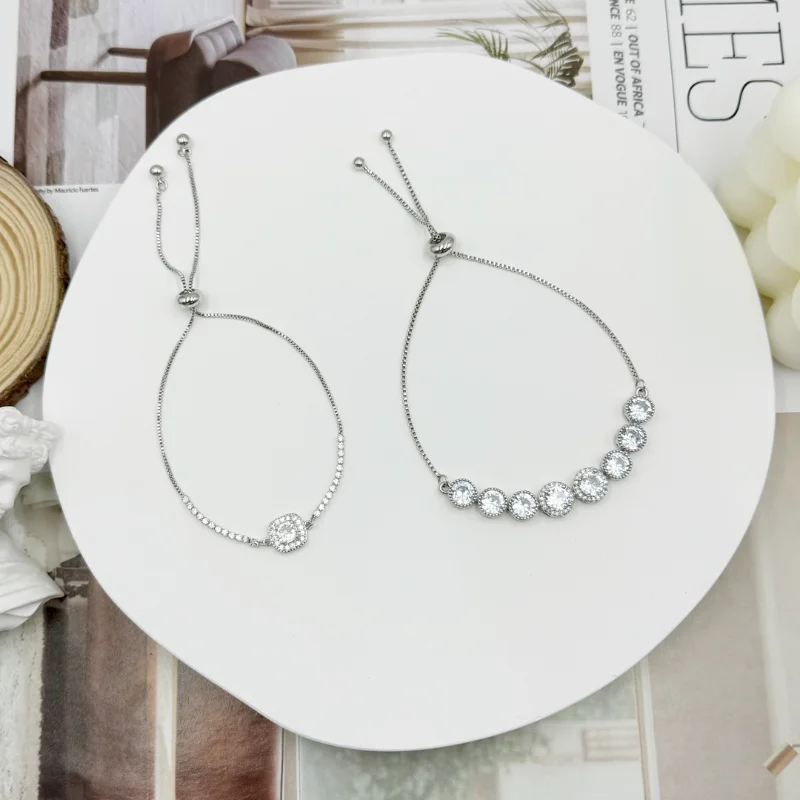 Silver round crystal adjustable bracelets set with sliding chains, transparent crystal round charms and delicate styles for wholesale jewelry buyers