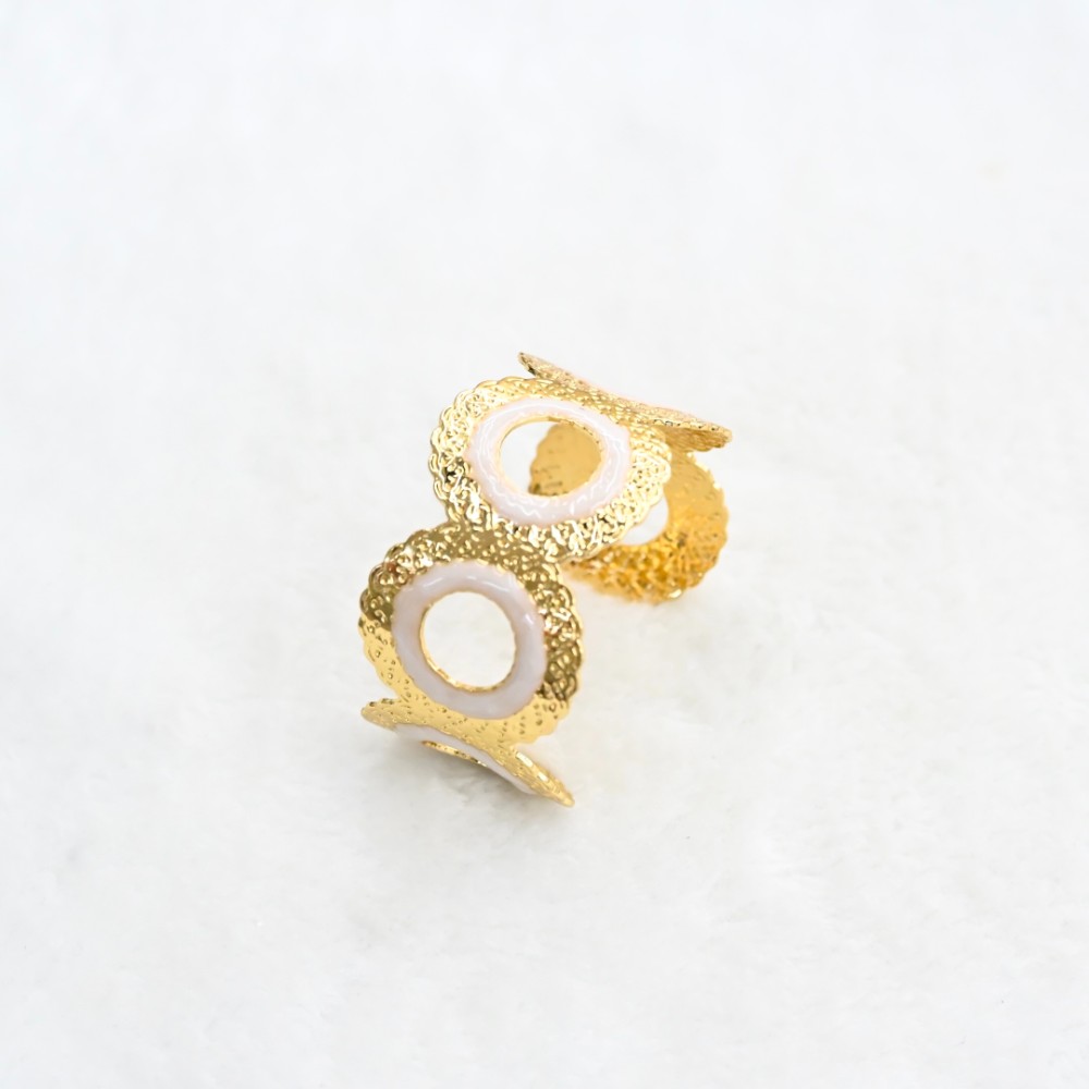 White circle gold cuff bracelet with round openwork design, textured gold-tone frame and white enamel-style ring details for wholesale jewelry buyers