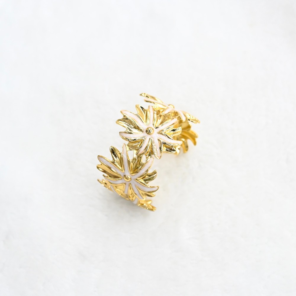White floral open cuff bracelet with gold-tone flower cutout design, soft white enamel-style petals and statement bracelet style for wholesale jewelry buyers