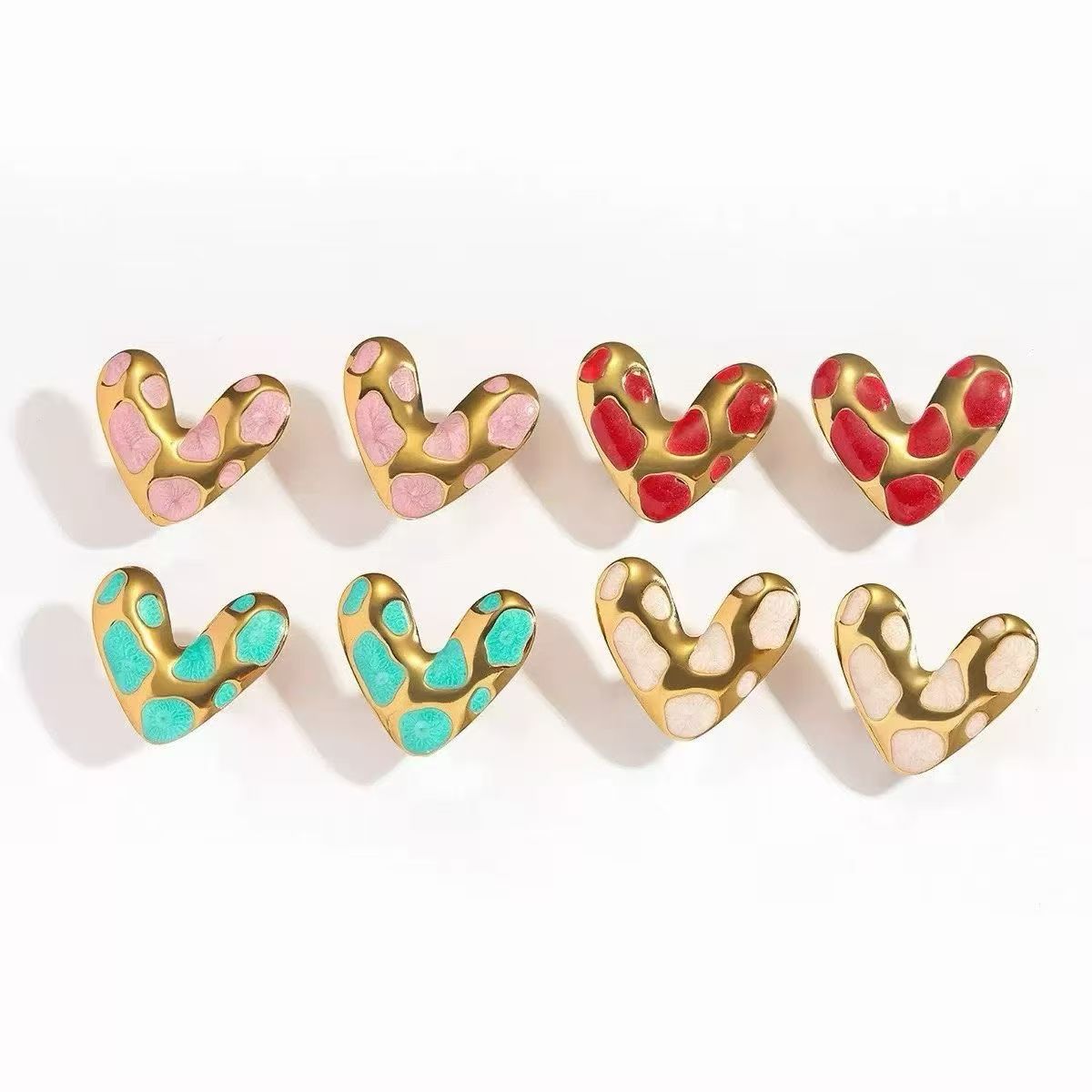 Assorted gold heart stud earrings with colorful enamel-style pink, red, turquoise and cream spotted heart designs for wholesale jewelry buyers