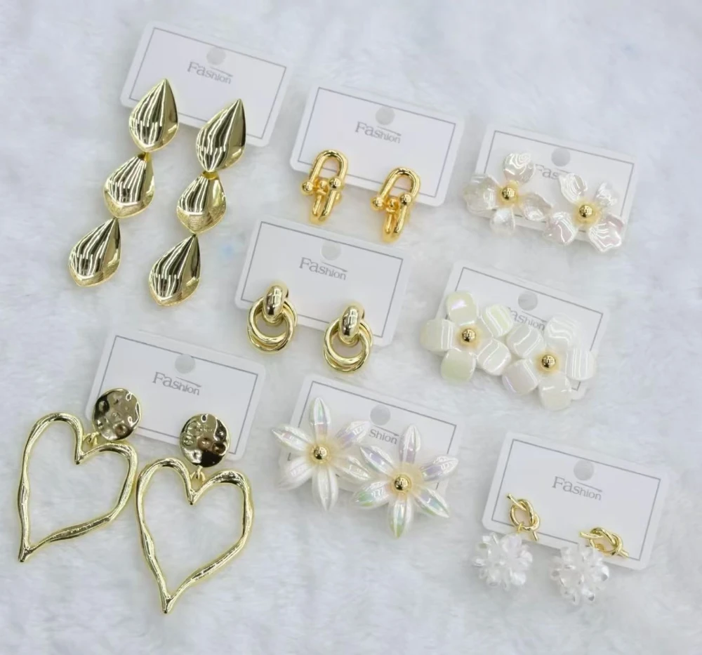Assorted gold statement earrings with flower, heart and pearl-inspired motifs for wholesale jewelry buyers