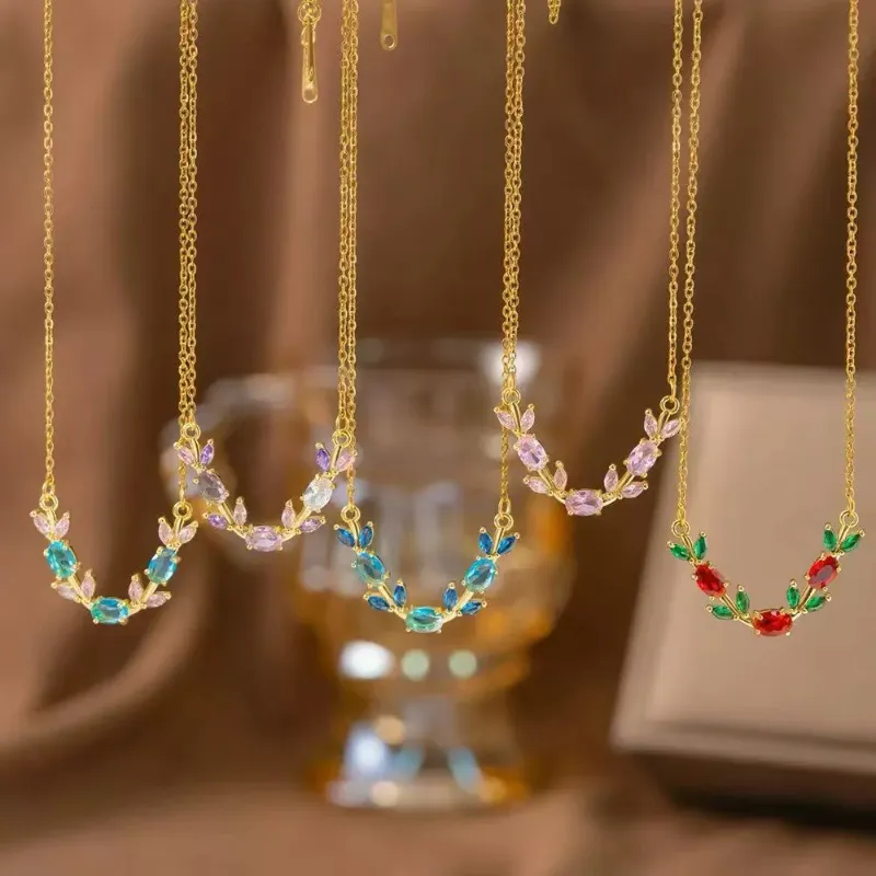 Gold colorful crystal floral necklaces set with blue, pink, purple, green and red stone branch pendant designs for wholesale jewelry buyers