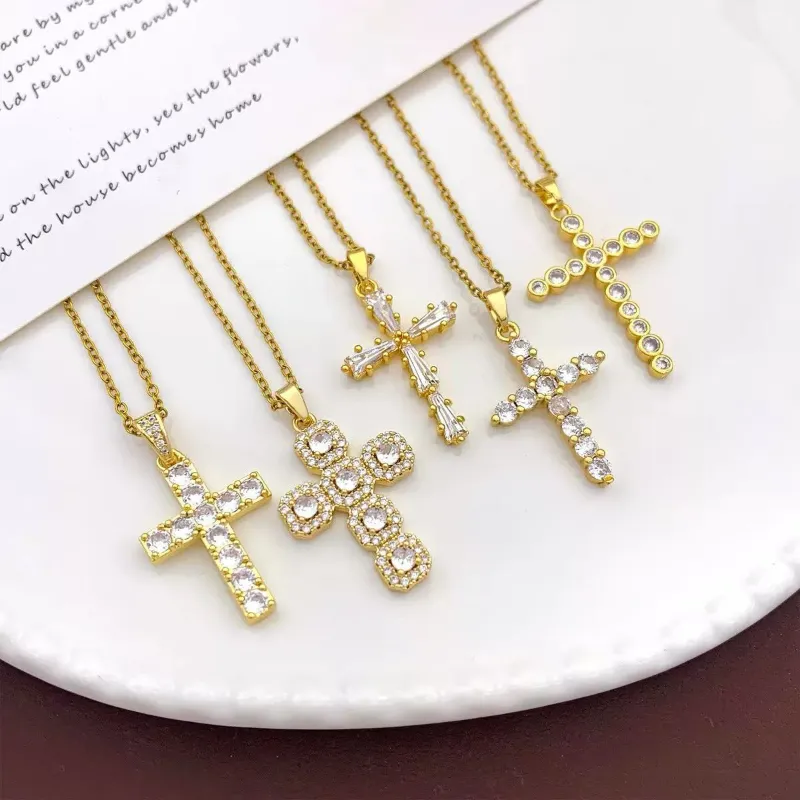 Gold crystal cross pendant necklaces set with rhinestone cross designs, clear stone details and religious gift jewelry styles for wholesale jewelry buyers