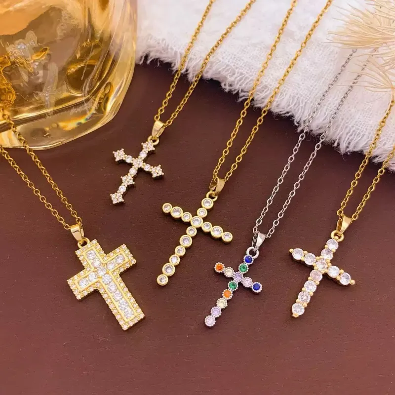 Gold and silver crystal cross necklaces set with rhinestone, multicolor stone and delicate cross pendant designs for wholesale jewelry buyers