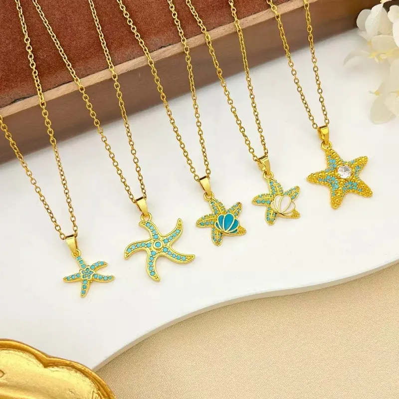 Gold turquoise ocean pendant necklaces set with starfish, turtle, shell and blue stone designs for wholesale jewelry buyers