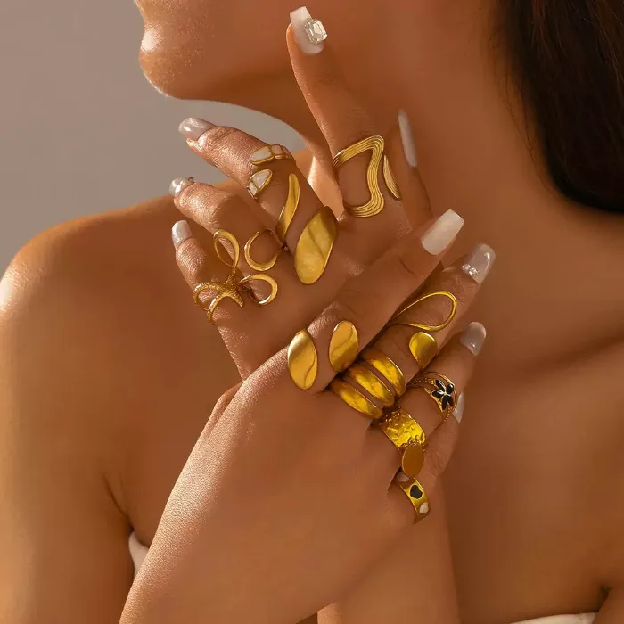Gold bold geometric rings set with abstract, textured, oval, loop and statement ring designs shown on hand for wholesale jewelry buyers