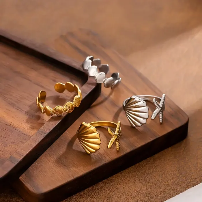 Ocean shell starfish open rings set in gold and silver colors with seashell, starfish and coastal designs for wholesale jewelry buyers