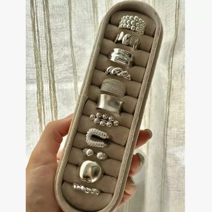 Silver chunky statement rings set with beaded, wavy, wide band, pearl and textured ring designs displayed in a ring tray for wholesale jewelry buyers